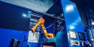 Robotyczne ramię w fabryce. Nowoczesny przemysł ciężki, technologia i uczenie maszynowe